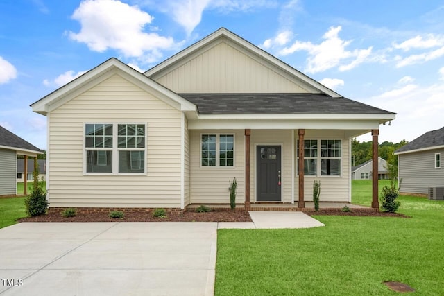 view of front of house with cooling unit and a front yard