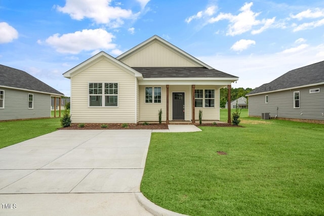 view of front of house with cooling unit and a front lawn