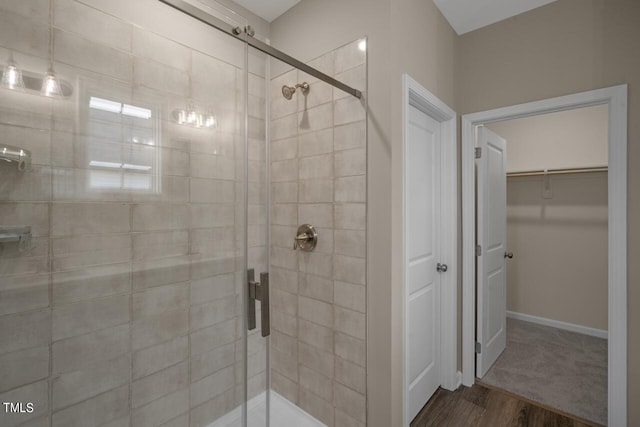 bathroom featuring wood-type flooring and a shower with door