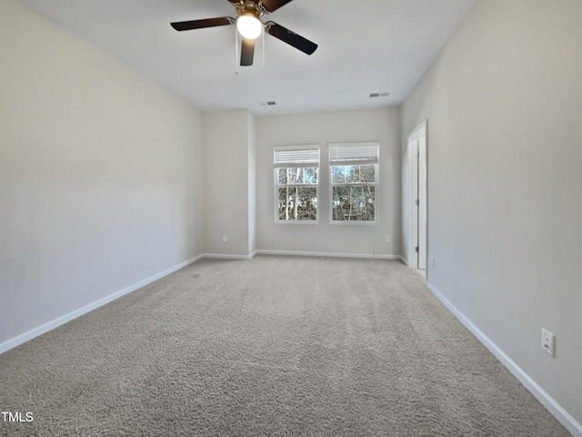 spare room with light colored carpet and ceiling fan