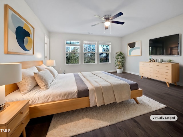 bedroom with ceiling fan and dark wood-type flooring