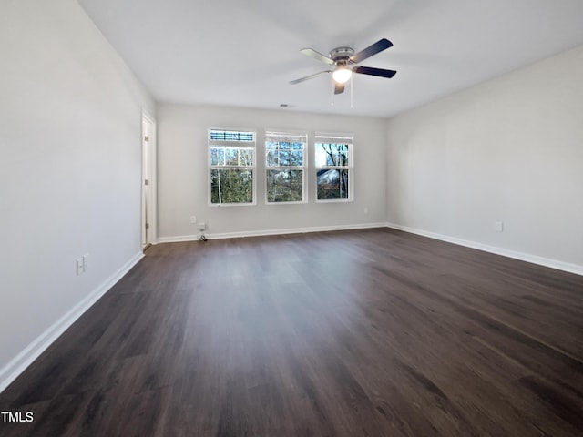 spare room featuring dark hardwood / wood-style floors and ceiling fan