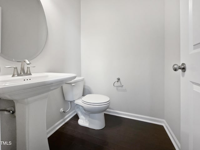 bathroom with toilet and hardwood / wood-style flooring