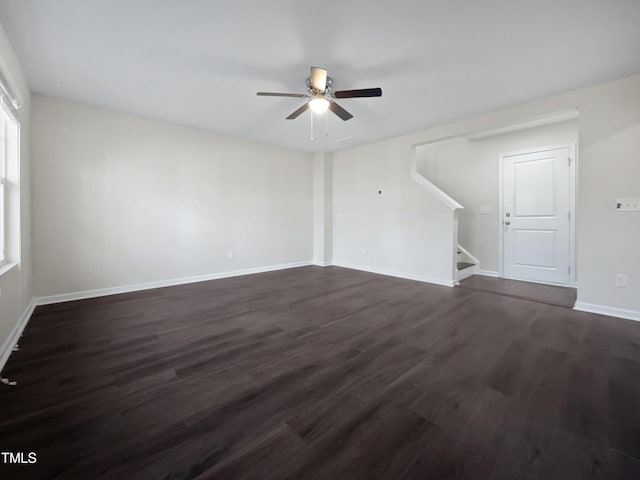 unfurnished living room featuring ceiling fan and dark hardwood / wood-style flooring