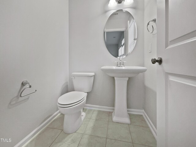 bathroom with tile patterned flooring and toilet