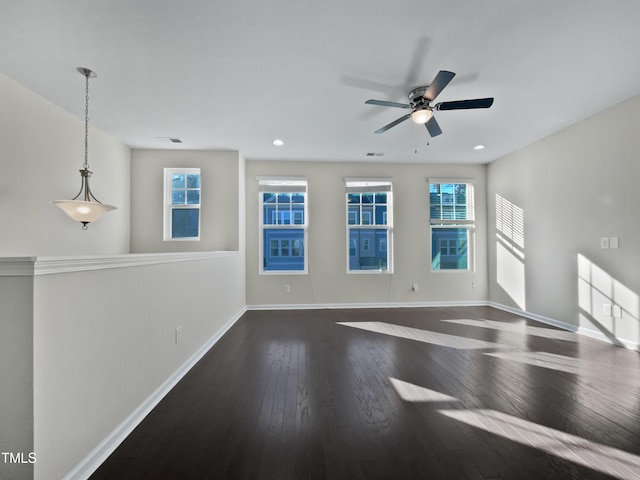 unfurnished room with dark hardwood / wood-style flooring and ceiling fan