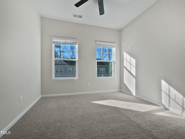 carpeted empty room featuring ceiling fan