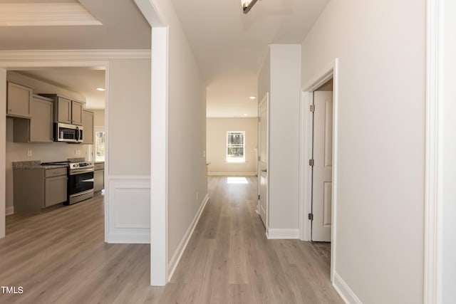 hall with crown molding and light wood-type flooring