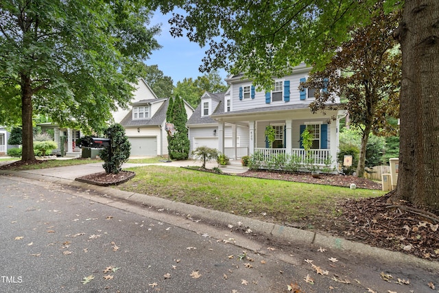 traditional-style home with covered porch, concrete driveway, and a garage