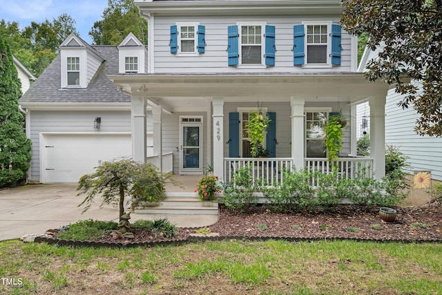 view of front of house with covered porch, concrete driveway, an attached garage, and a shingled roof