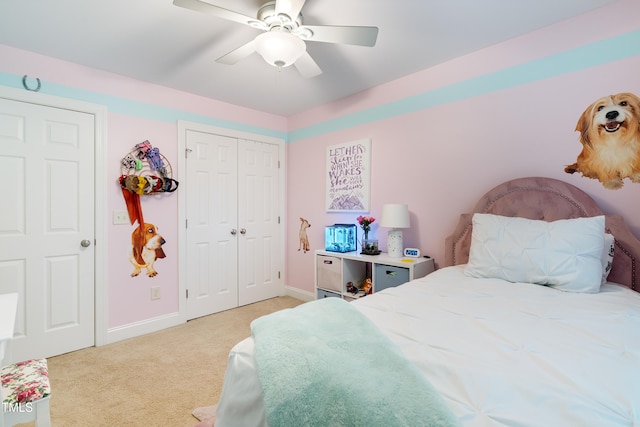 bedroom with light carpet, baseboards, a ceiling fan, and a closet