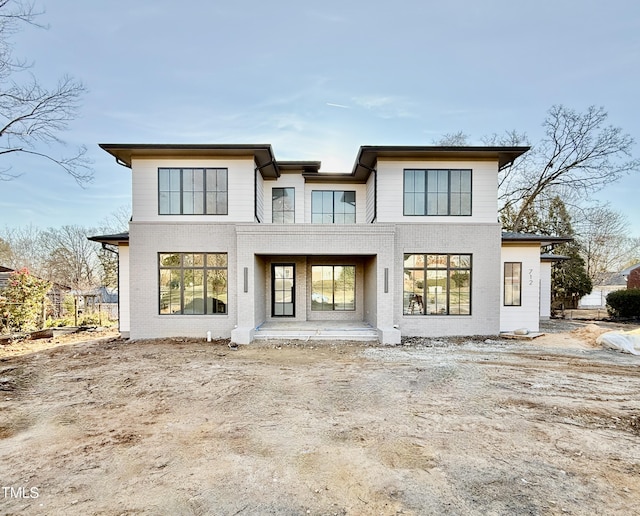 rear view of house featuring a balcony and a patio area