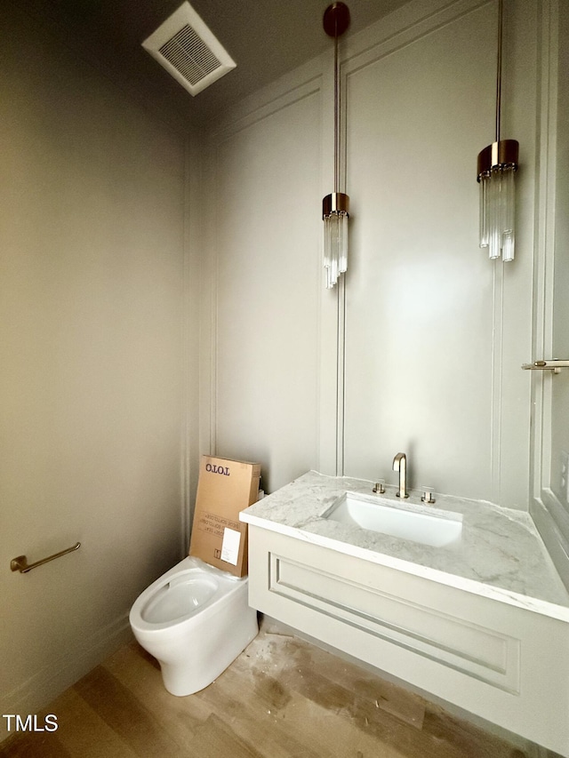 bathroom with vanity and wood-type flooring