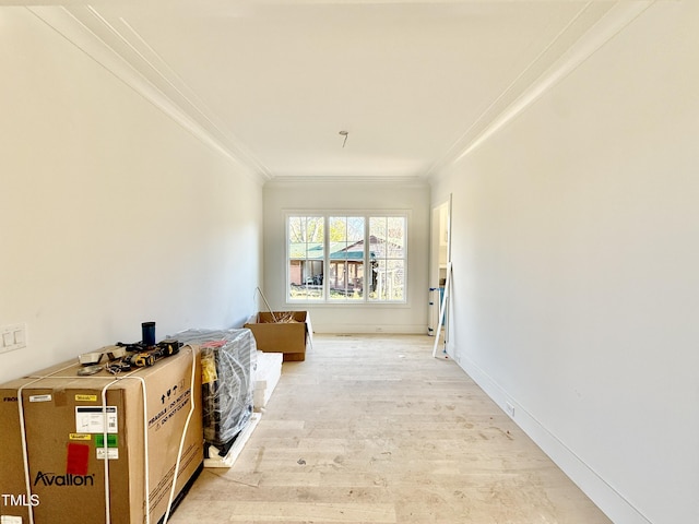 corridor featuring crown molding and light hardwood / wood-style floors