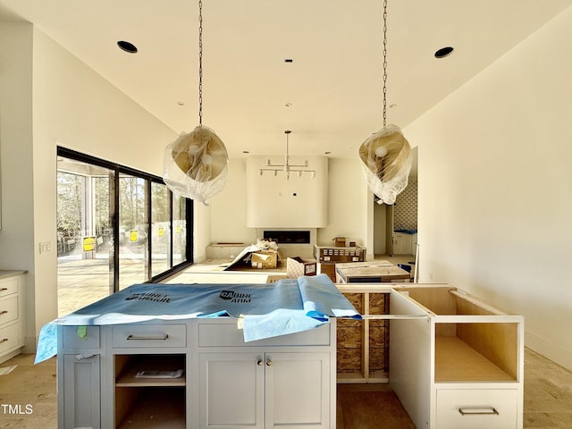 kitchen featuring white cabinetry, hanging light fixtures, and a center island