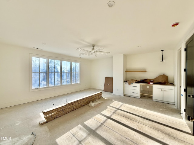 interior space with ceiling fan