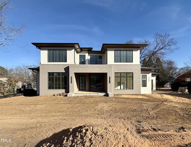 rear view of house featuring brick siding