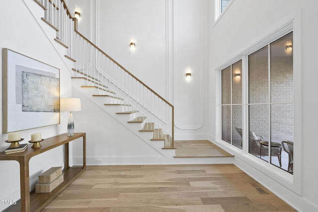 712 Daniels St, Raleigh, NC 27605 - staircase featuring a towering ceiling, visible vents, wood finished floors, and baseboards