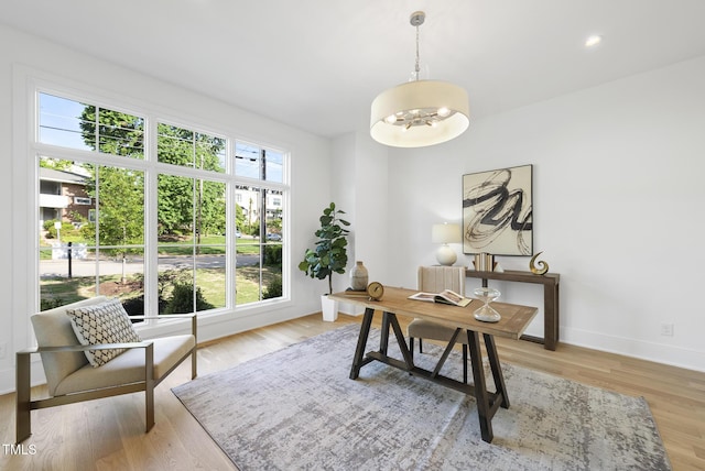 712 Daniels St, Raleigh, NC 27605 - office area featuring light wood-style flooring, baseboards, and an inviting chandelier
