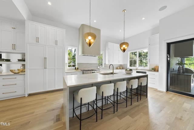 712 Daniels St, Raleigh, NC 27605 - kitchen with backsplash, visible vents, a sink, and white cabinetry