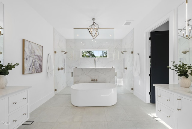 712 Daniels St, Raleigh, NC 27605 - full bath with a marble finish shower, visible vents, baseboards, a freestanding tub, and vanity
