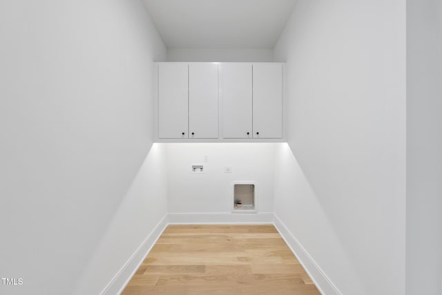712 Daniels St, Raleigh, NC 27605 - clothes washing area with hookup for an electric dryer, light wood-style flooring, baseboards, hookup for a washing machine, and cabinet space