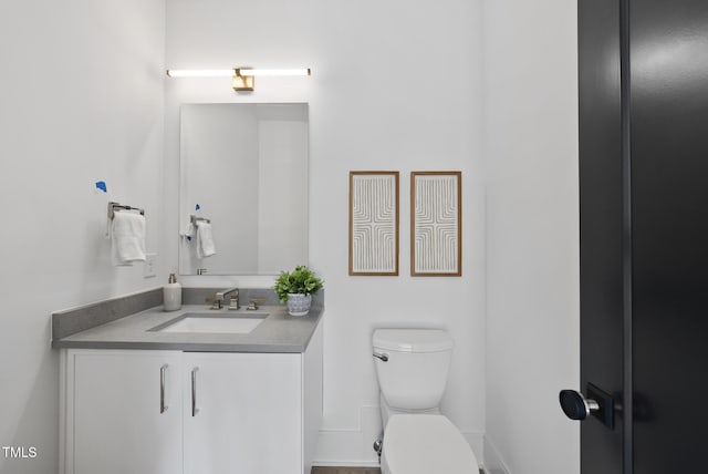 712 Daniels St, Raleigh, NC 27605 - bathroom with toilet, vanity, and baseboards
