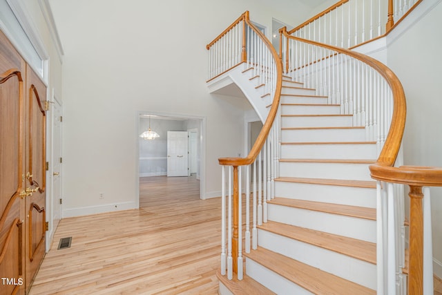 stairs featuring hardwood / wood-style floors