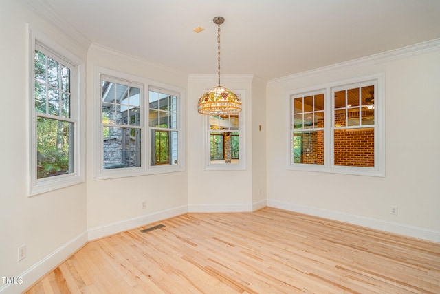 unfurnished dining area with crown molding and wood-type flooring