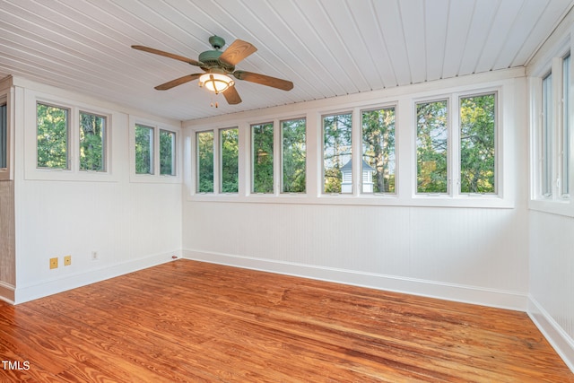 unfurnished sunroom with a wealth of natural light, ceiling fan, and wooden ceiling