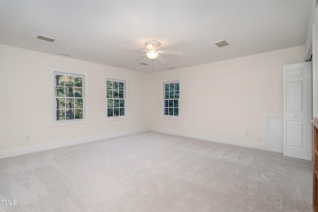 unfurnished room with ceiling fan and light carpet