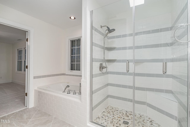 bathroom featuring plus walk in shower and tile patterned floors