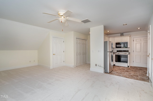 kitchen featuring light carpet, stainless steel fridge, white cabinetry, and white range with electric cooktop