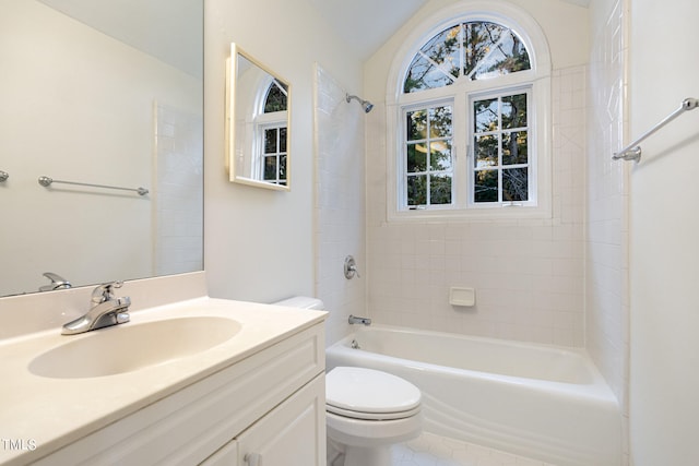 full bathroom with lofted ceiling, toilet, vanity, tiled shower / bath combo, and tile patterned flooring