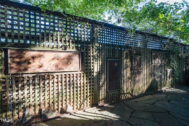 view of gate with a patio