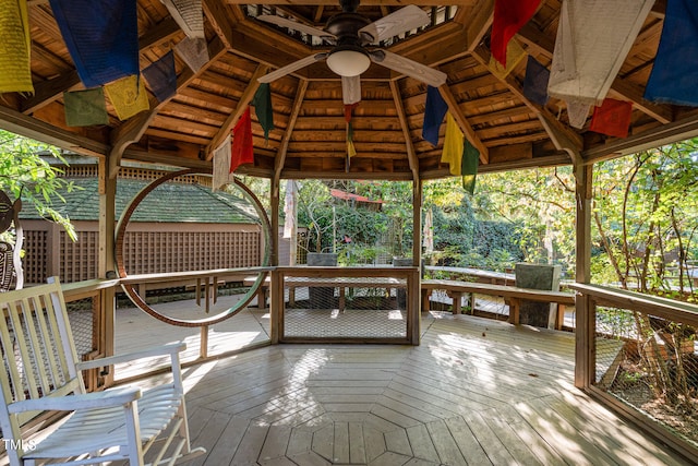 wooden deck with a gazebo and ceiling fan