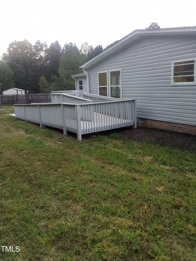 wooden terrace with a yard