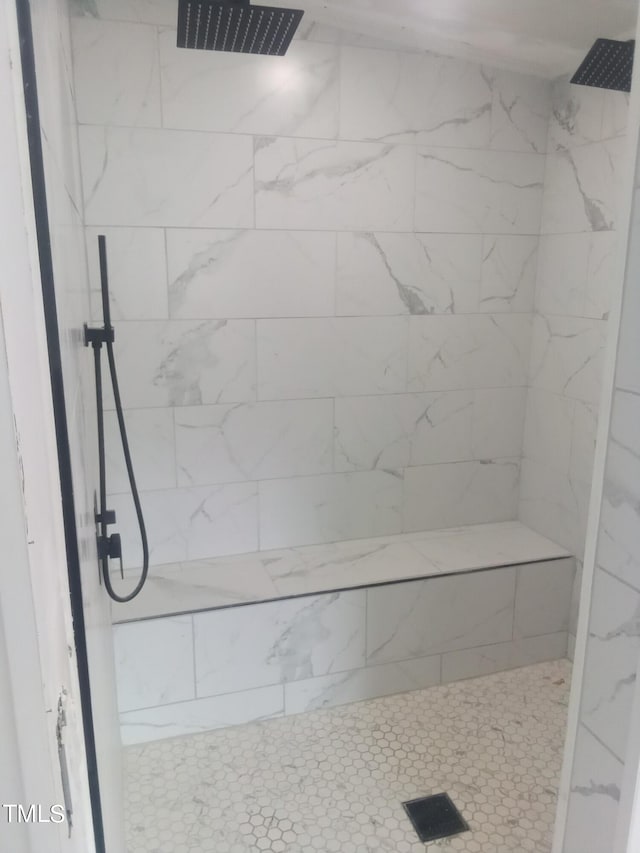 bathroom with tiled shower