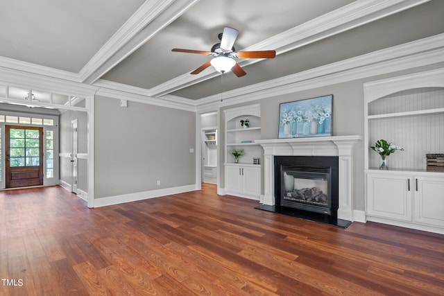 unfurnished living room featuring built in shelves, ornamental molding, dark hardwood / wood-style flooring, and ceiling fan