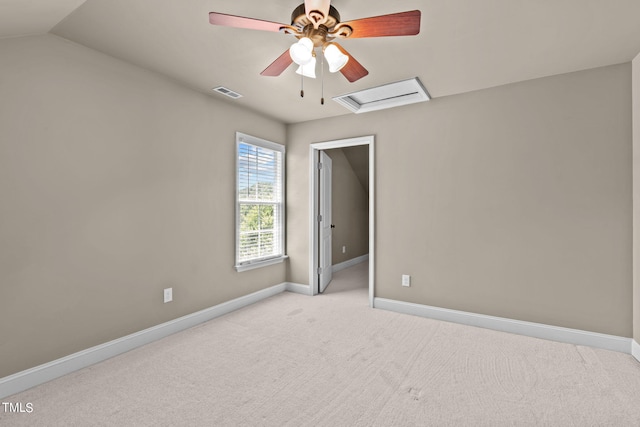 carpeted spare room with vaulted ceiling and ceiling fan