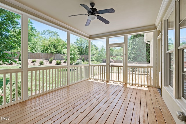 unfurnished sunroom with ceiling fan