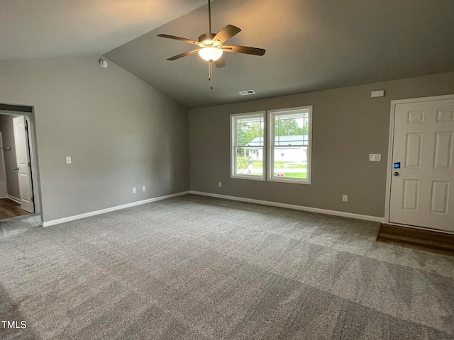 unfurnished living room with ceiling fan, carpet floors, and vaulted ceiling