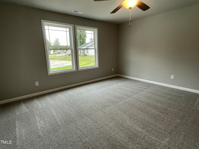 carpeted empty room featuring ceiling fan