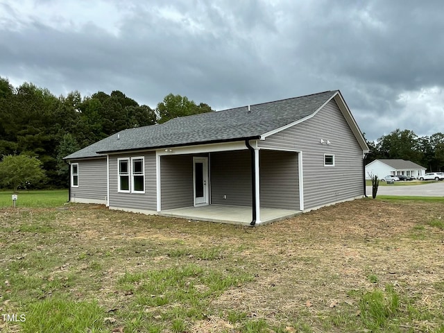 back of house with a yard and a patio area