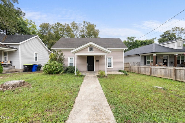 bungalow-style house featuring a front lawn