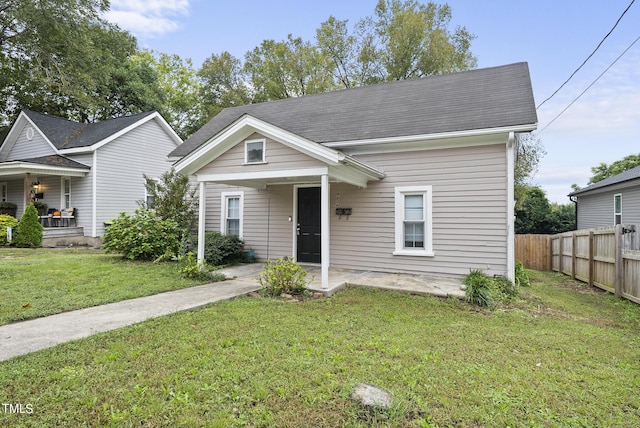 view of front facade with a front lawn and fence