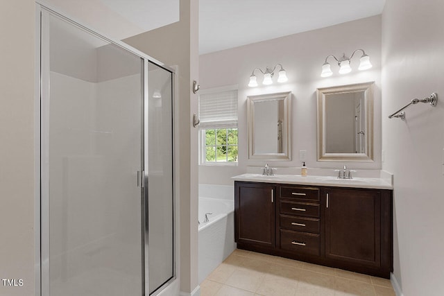 bathroom featuring shower with separate bathtub, vanity, and tile patterned floors