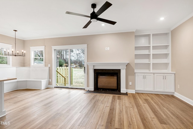 unfurnished living room featuring ceiling fan, ornamental molding, and light wood-type flooring