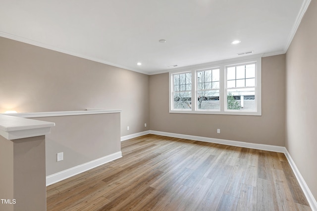 unfurnished room with ornamental molding and light hardwood / wood-style floors