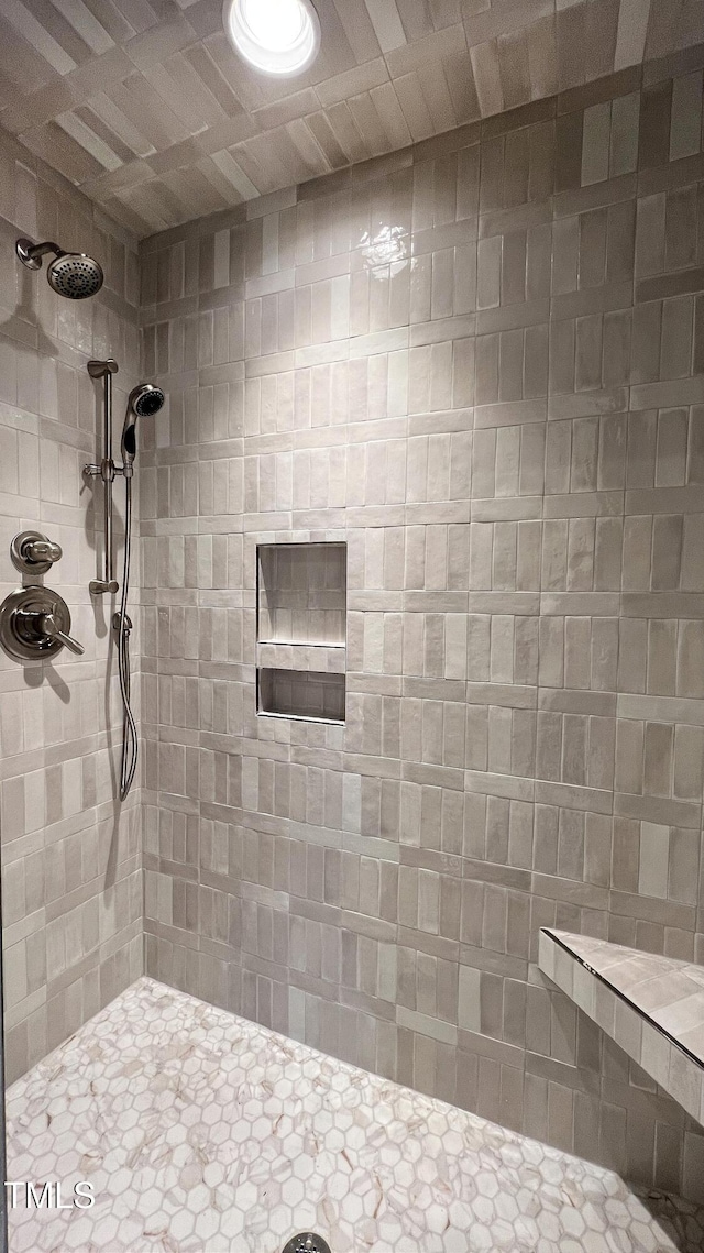 bathroom with tiled shower